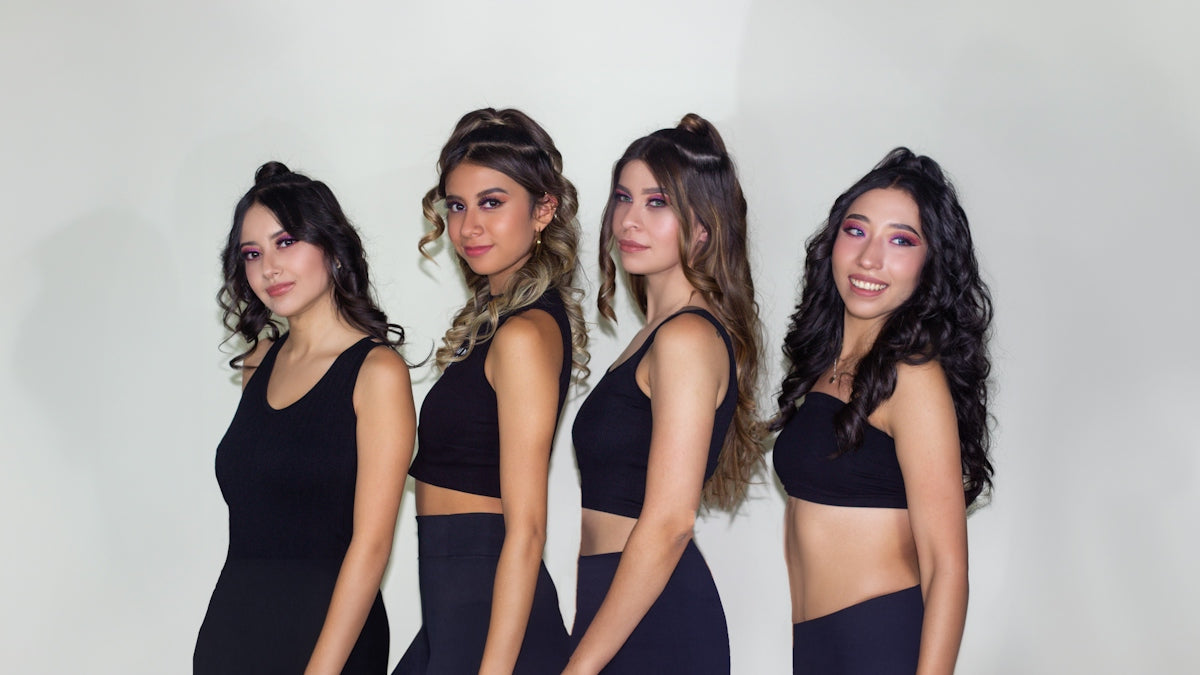 a group of beautiful women standing next to each other